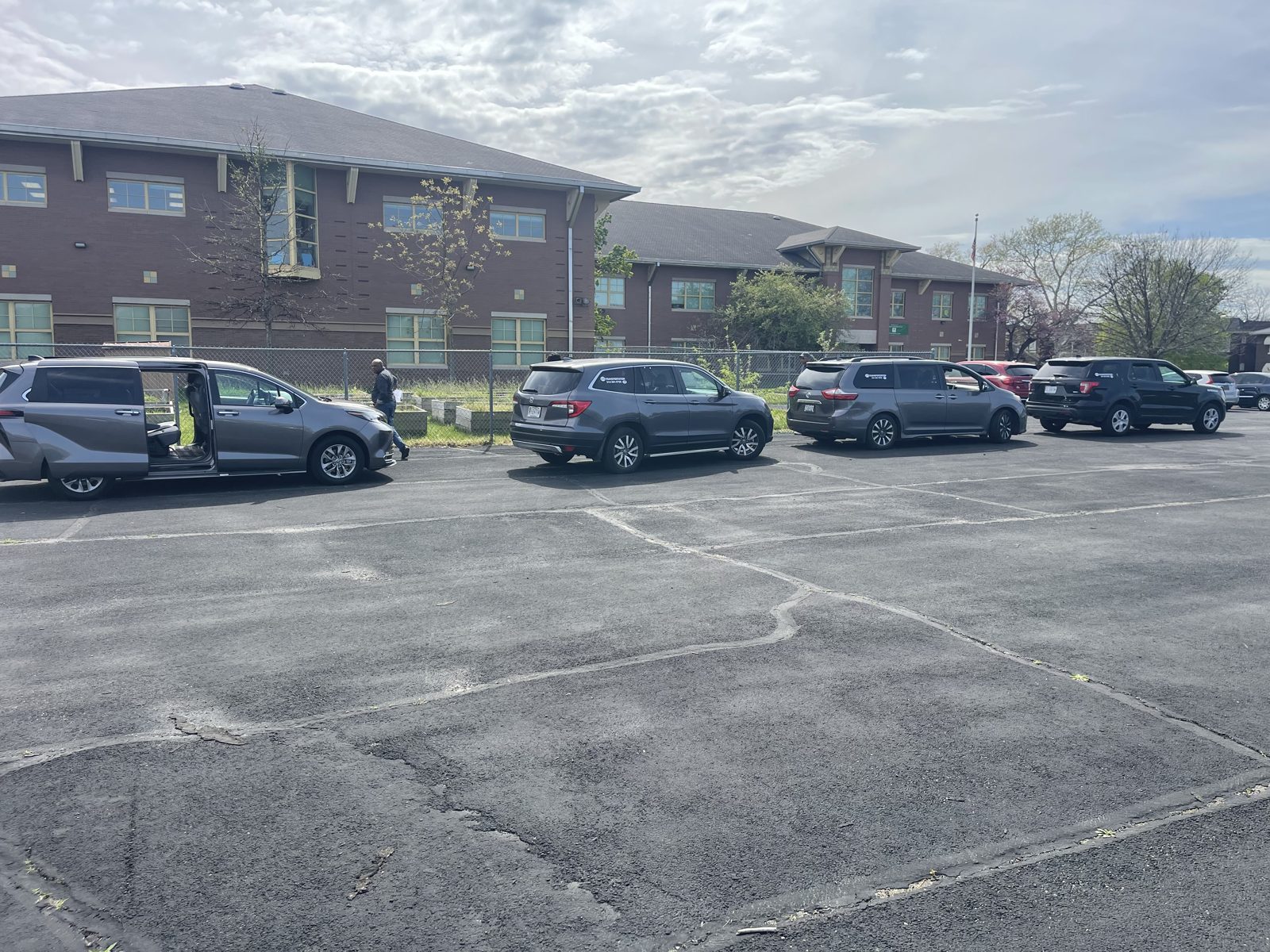 STL Transportation vehicles waiting in a school pickup line