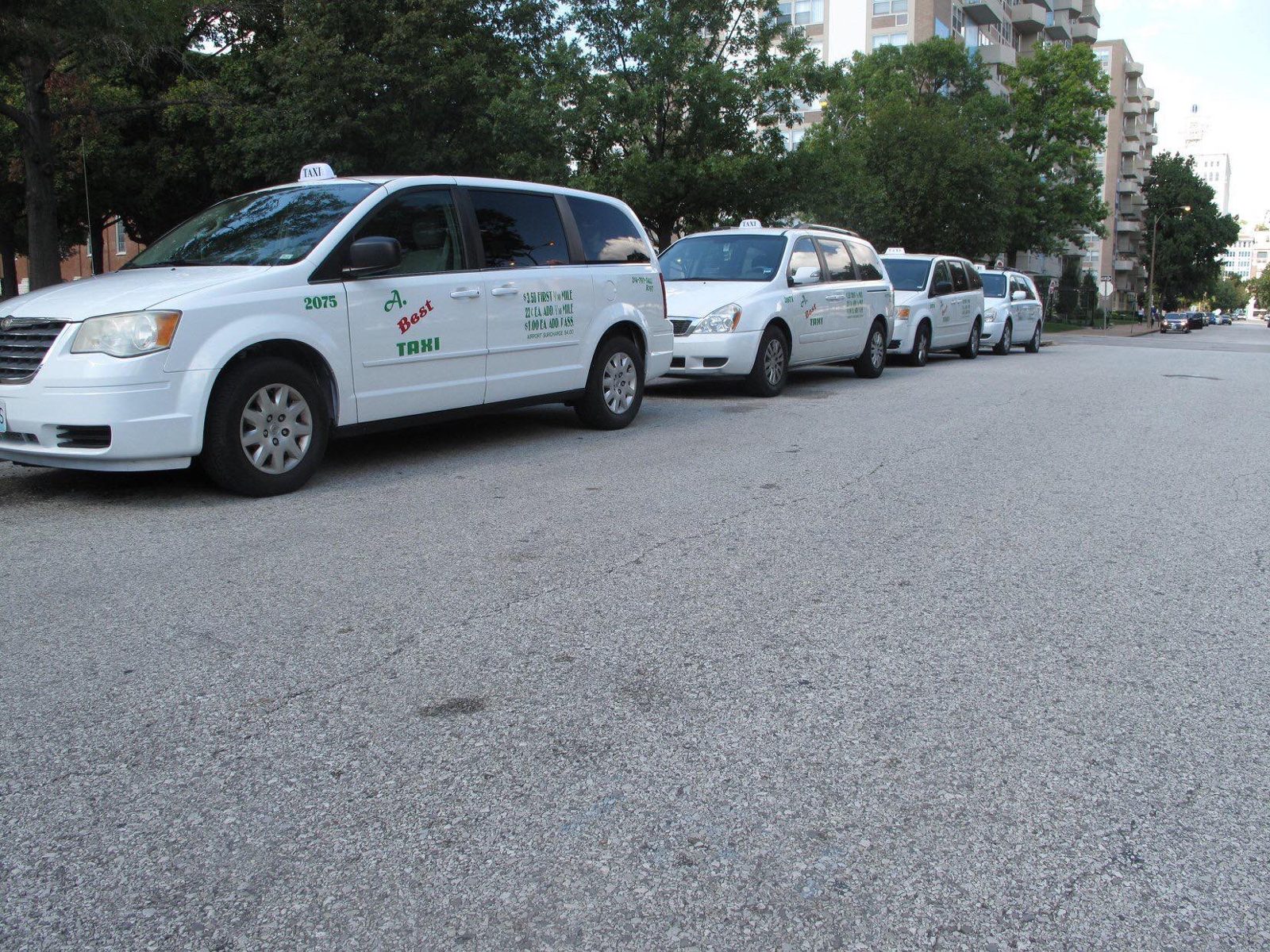 Taxi vans lined up on a St. Louis street