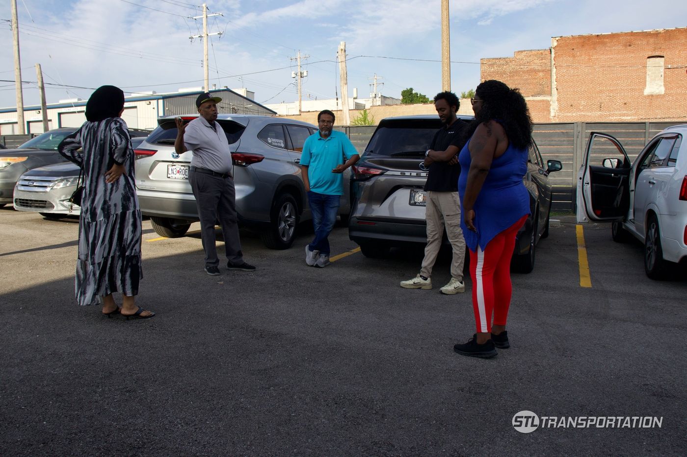STL Transportation drivers and dispatch staff talking at the company lot