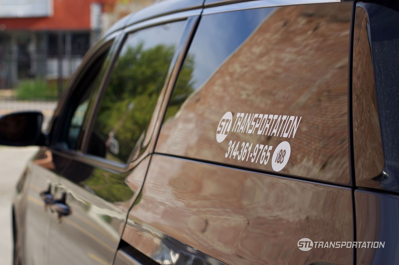 STL Transportation decal and unit number on a fleet vehicle window